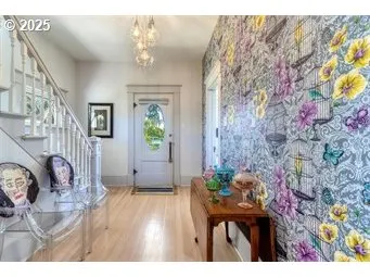 a view of entryway with livingroom and chandelier