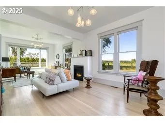 a living room with furniture fireplace and a large window