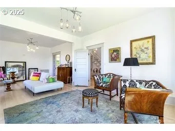 a living room with furniture and a chandelier