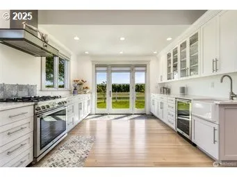 a open kitchen with granite countertop a stove top oven sink and cabinets