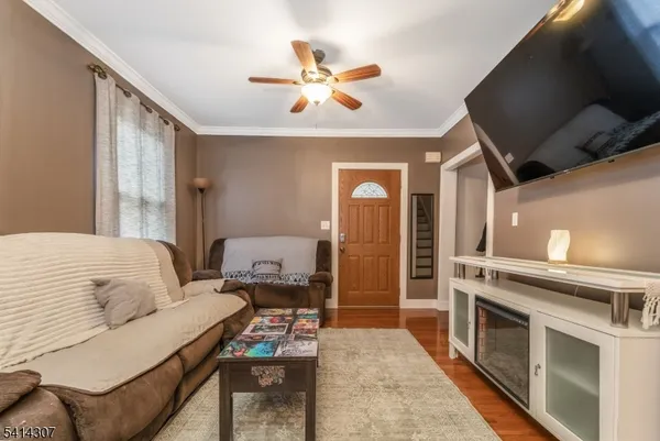 a living room with a fireplace furniture a fireplace and a flat screen tv