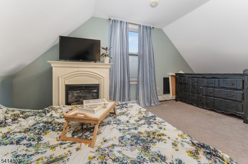 409 Boonton Avenue Boonton, NJ 07005 - Photo 23 of 43 a living room with a fireplace furniture a fireplace and a flat screen tv