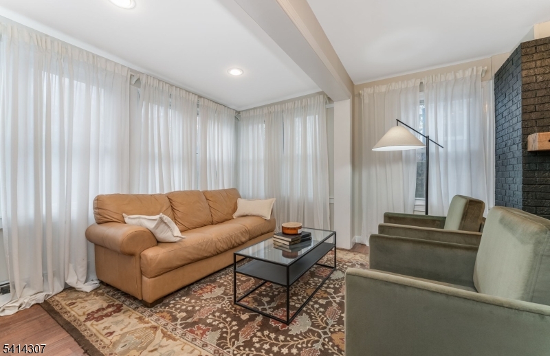 409 Boonton Avenue Boonton, NJ 07005 - Photo 29 of 43 a living room with furniture and a chandelier