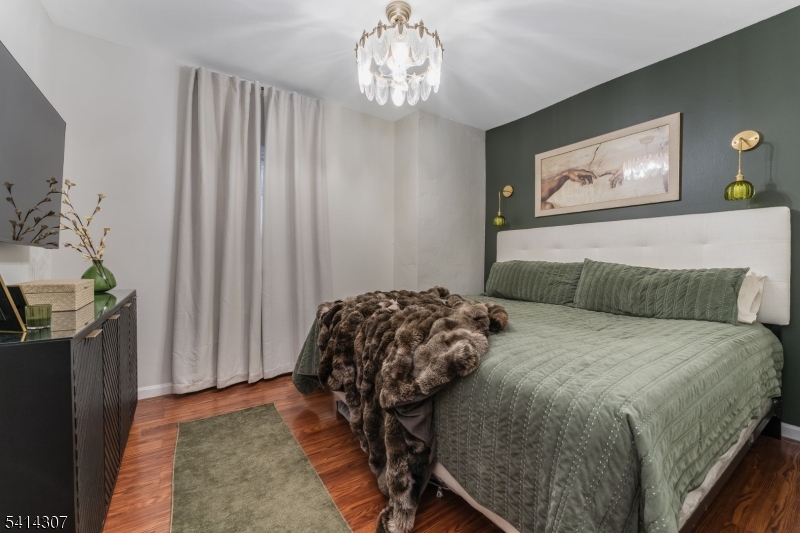 409 Boonton Avenue Boonton, NJ 07005 - Photo 40 of 43 a bedroom with a bed and a chandelier