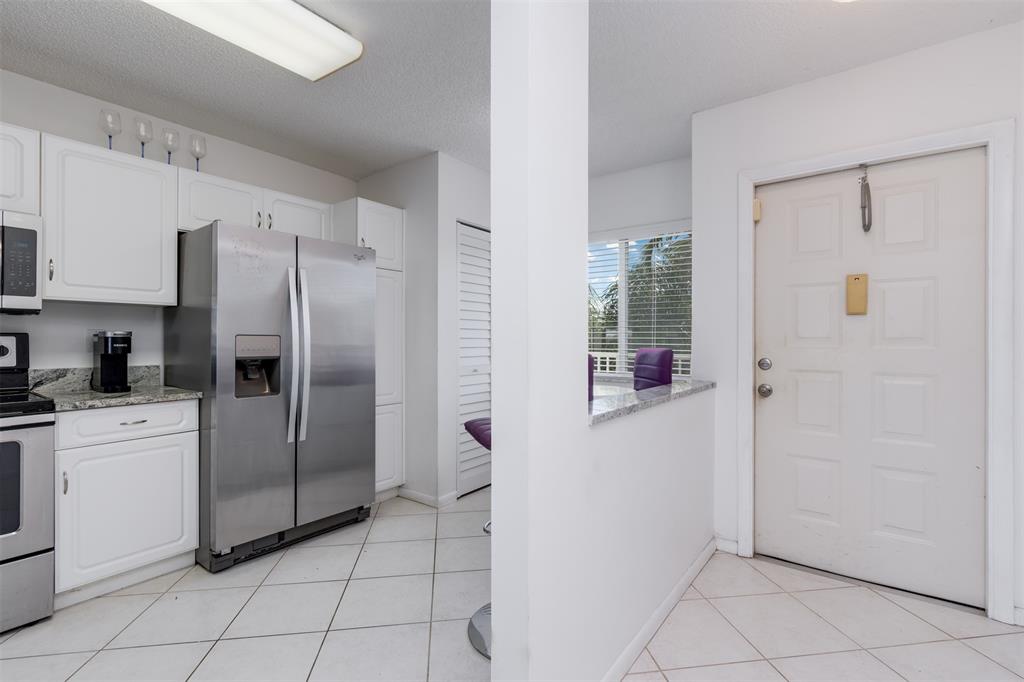 9537 Weldon Circle, Unit 404 Fort Lauderdale, FL 33321 - Photo 17 of 39 a kitchen with stainless steel appliances a refrigerator and a sink