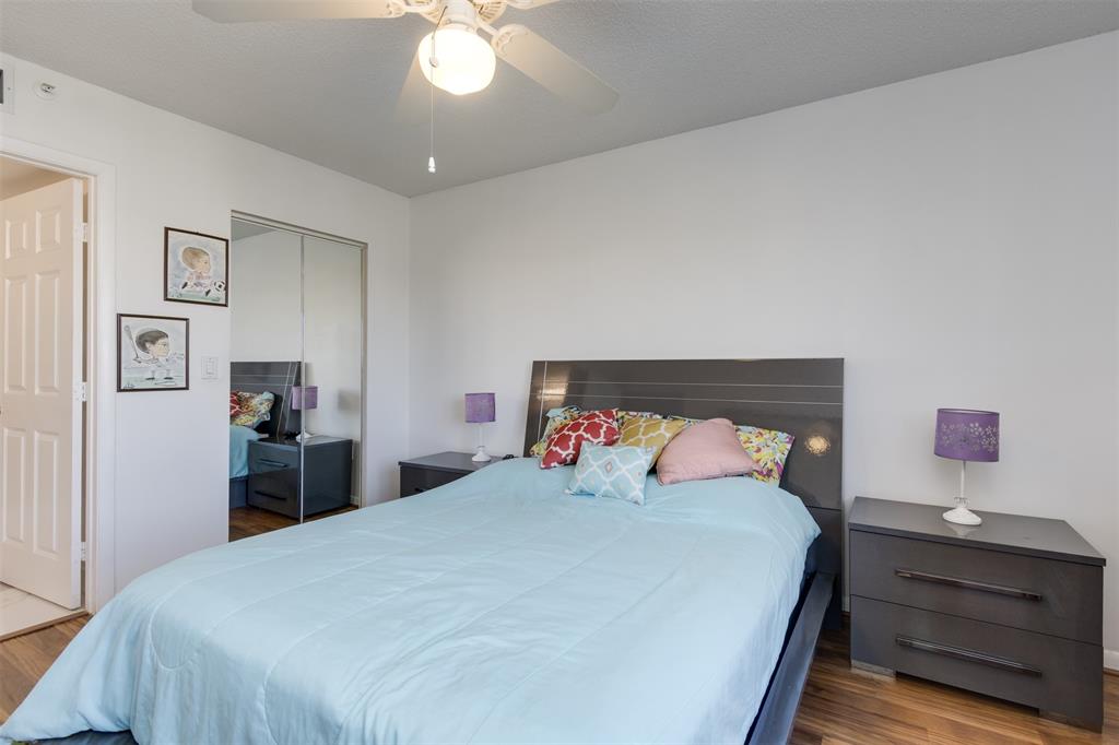 9537 Weldon Circle, Unit 404 Fort Lauderdale, FL 33321 - Photo 21 of 39 a bedroom with a bed and a chandelier