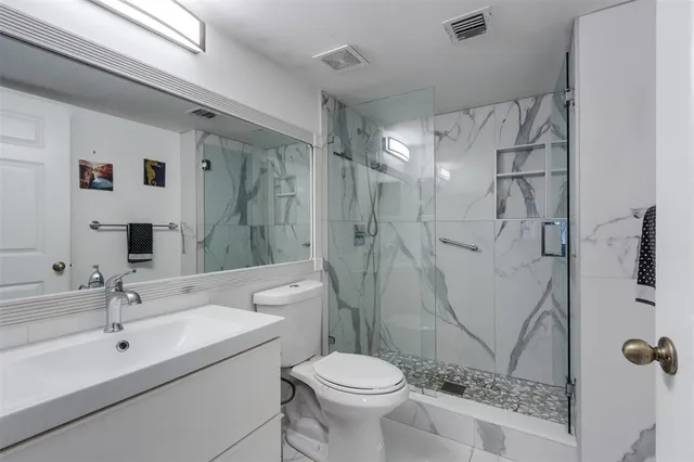 a bathroom with a sink a toilet and mirror