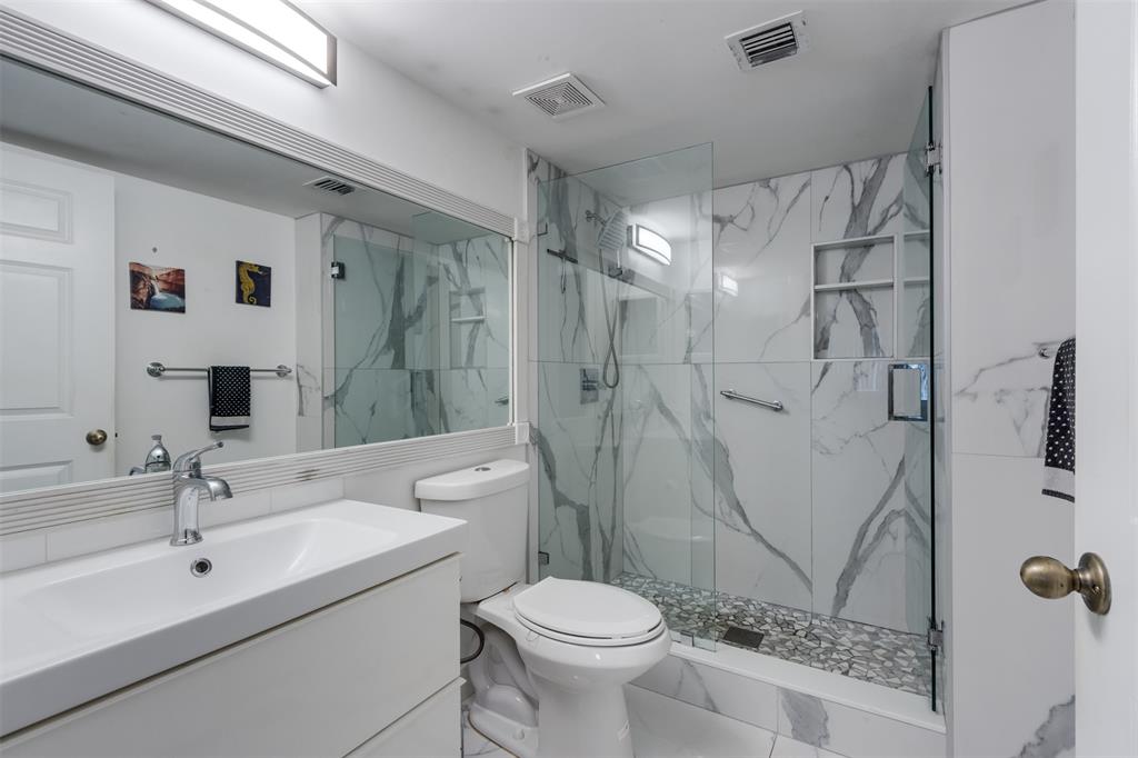 9537 Weldon Circle, Unit 404 Fort Lauderdale, FL 33321 - Photo 23 of 39 a bathroom with a sink toilet and shower