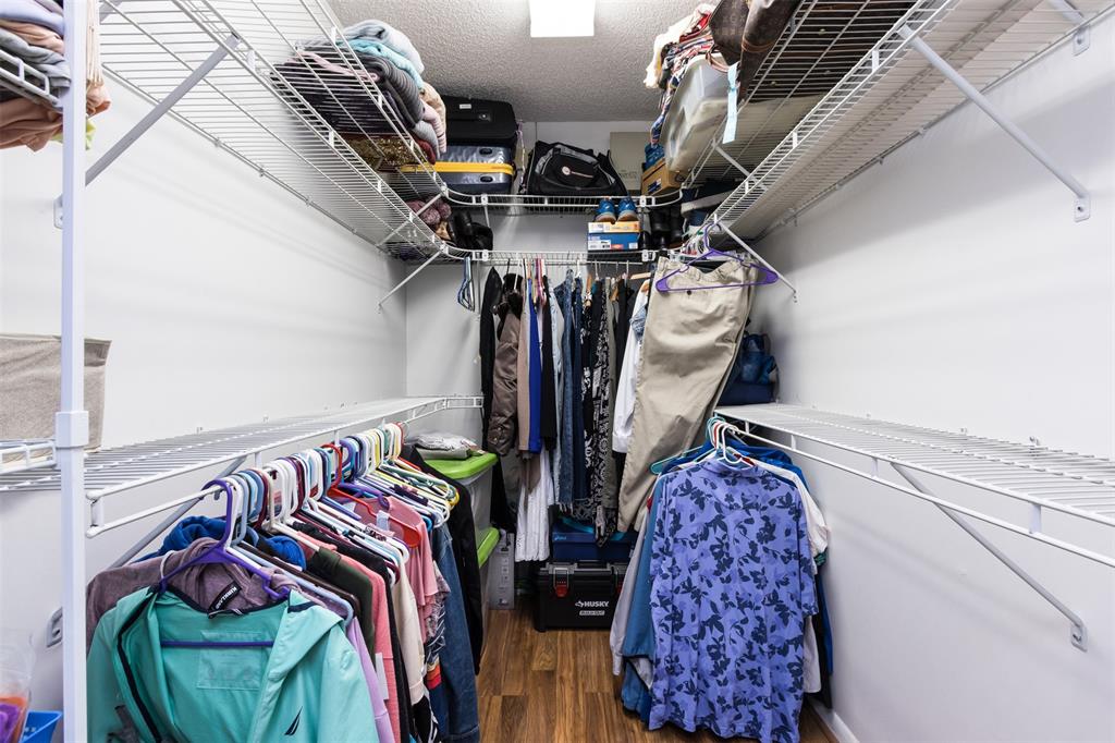 9537 Weldon Circle, Unit 404 Fort Lauderdale, FL 33321 - Photo 25 of 39 a view of walk in closet with clothes and shoes