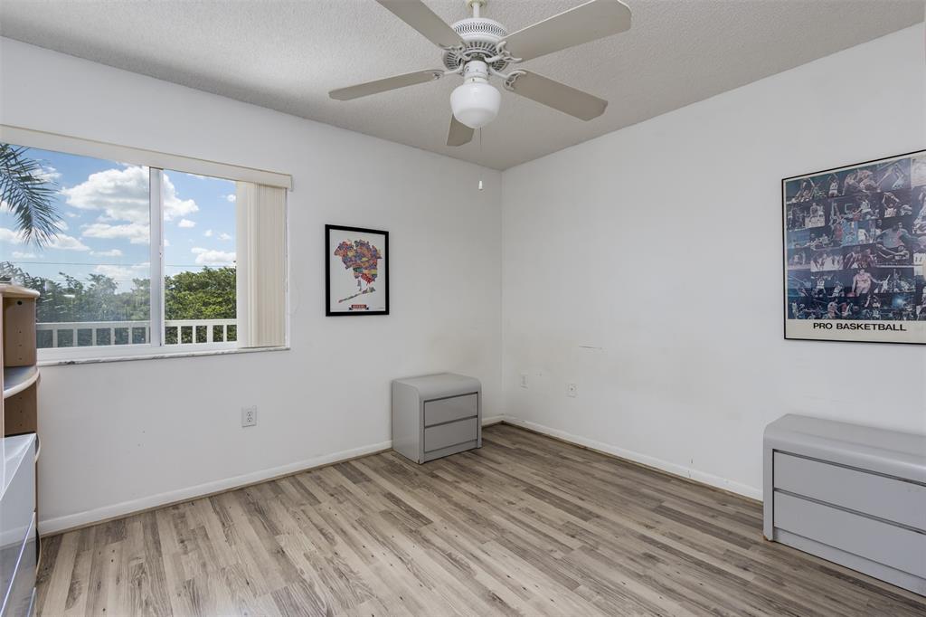 9537 Weldon Circle, Unit 404 Fort Lauderdale, FL 33321 - Photo 26 of 39 a view of room with window and wooden floor
