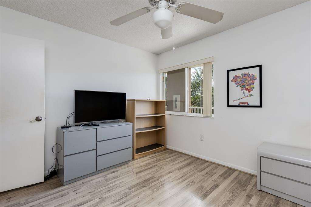 9537 Weldon Circle, Unit 404 Fort Lauderdale, FL 33321 - Photo 27 of 39 a view of a livingroom with racks on the wall