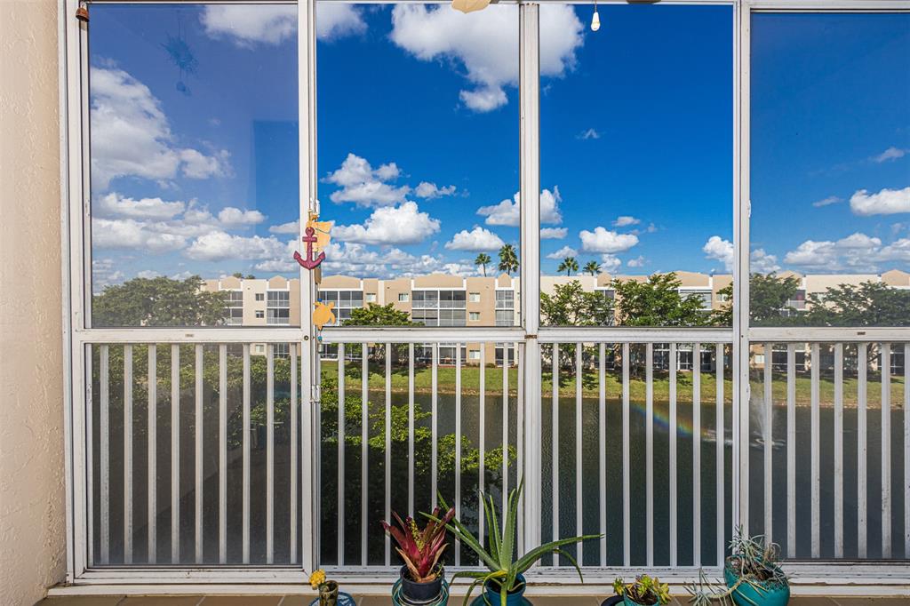 9537 Weldon Circle, Unit 404 Fort Lauderdale, FL 33321 - Photo 32 of 39 a view of a balcony with wooden floor