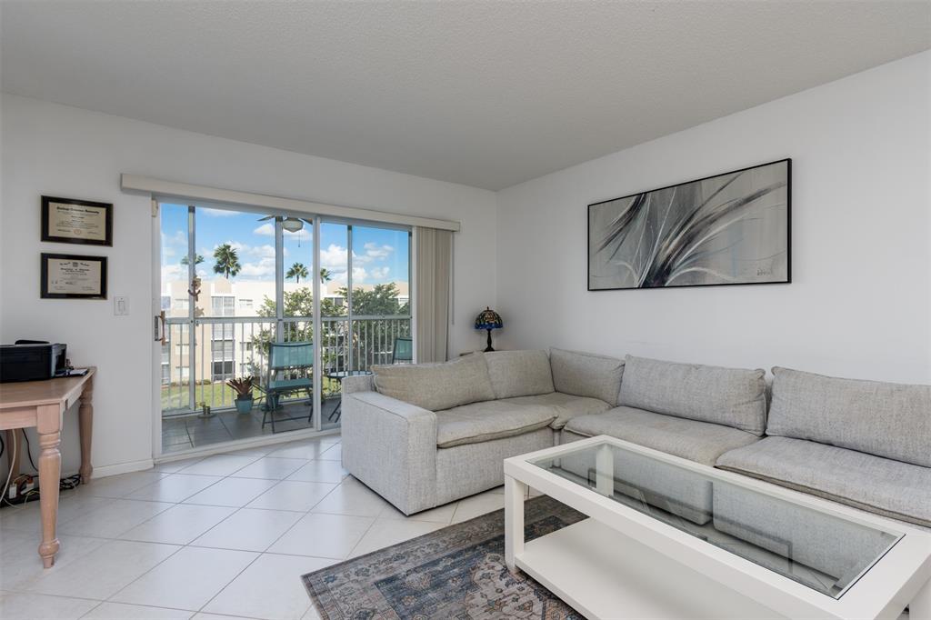 9537 Weldon Circle, Unit 404 Fort Lauderdale, FL 33321 - Photo 8 of 39 a living room with furniture and a large window