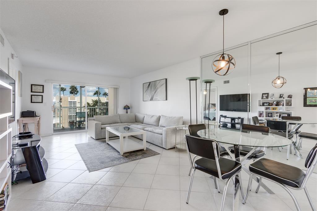 9537 Weldon Circle, Unit 404 Fort Lauderdale, FL 33321 - Photo 10 of 39 a living room with furniture and a flat screen tv