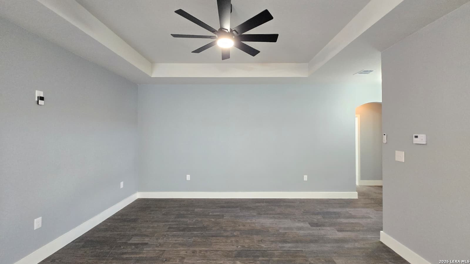 802 Cr 520 D'Hanis, TX 78850 - Photo 16 of 33 an empty room with wooden floor and a ceiling fan