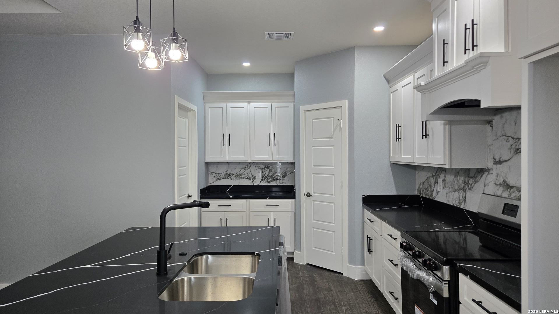 802 Cr 520 D'Hanis, TX 78850 - Photo 20 of 33 a kitchen with stainless steel appliances a stove a sink and a refrigerator