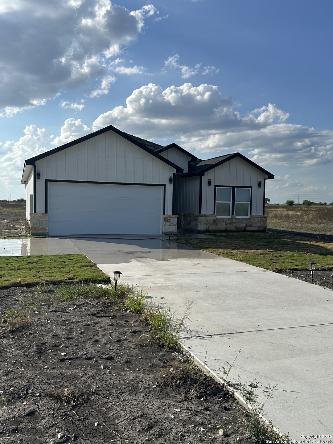 802 Cr 520 D'Hanis, TX 78850 - Photo 2 of 16 a front view of a house with a yard and garage