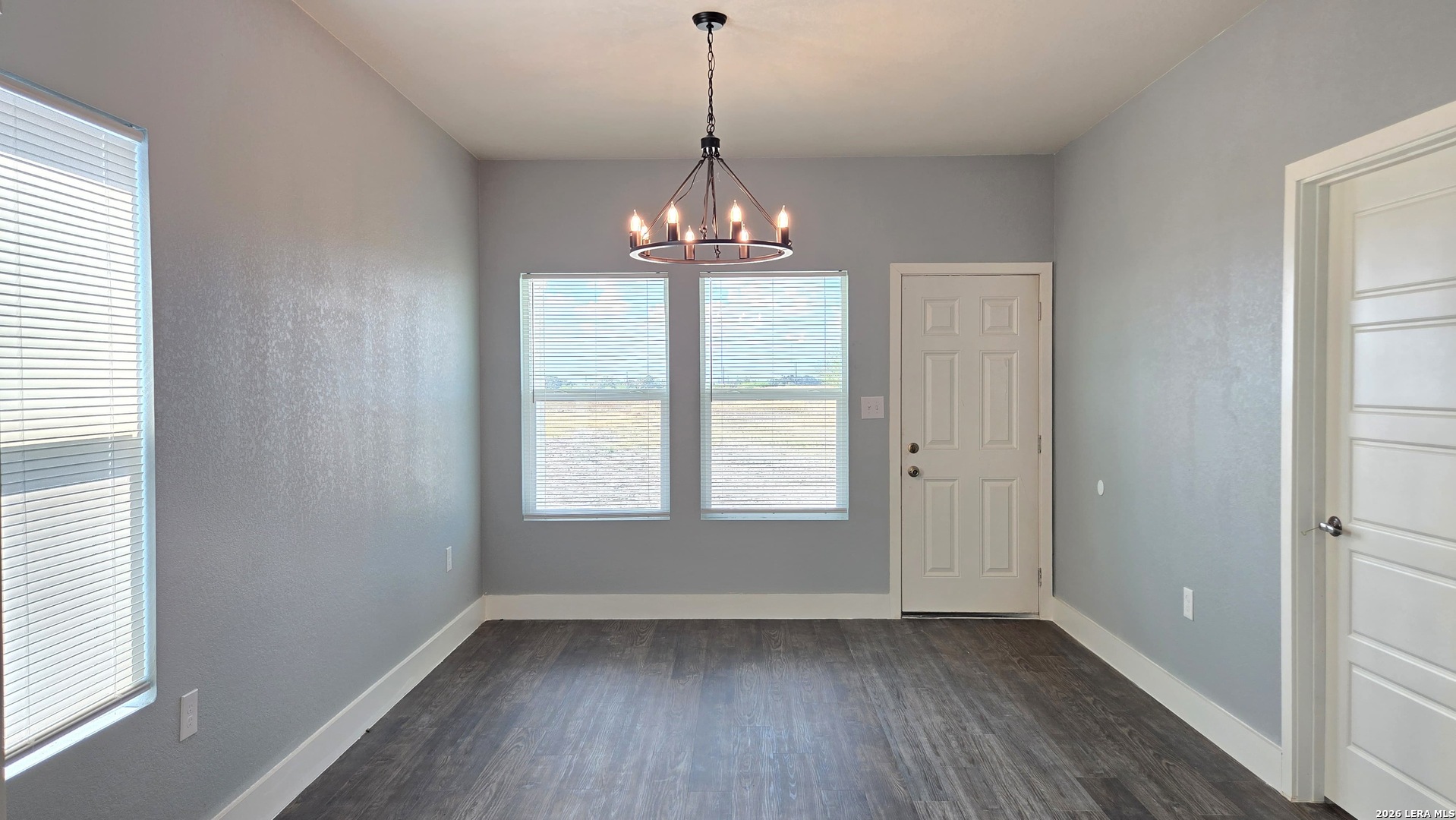 802 Cr 520 D'Hanis, TX 78850 - Photo 26 of 33 a view of an empty room with wooden floor and a window