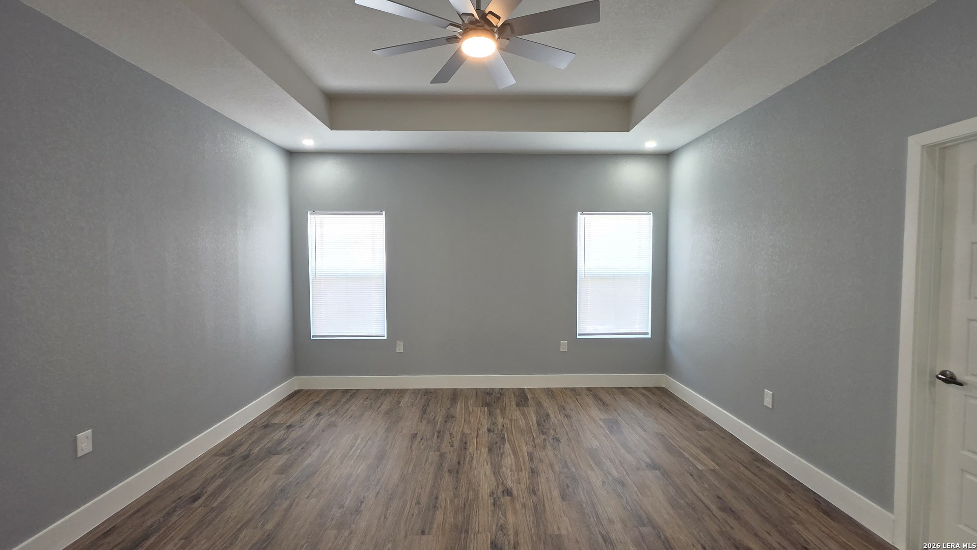 802 Cr 520 D'Hanis, TX 78850 - Photo 27 of 33 an empty room with wooden floor and windows