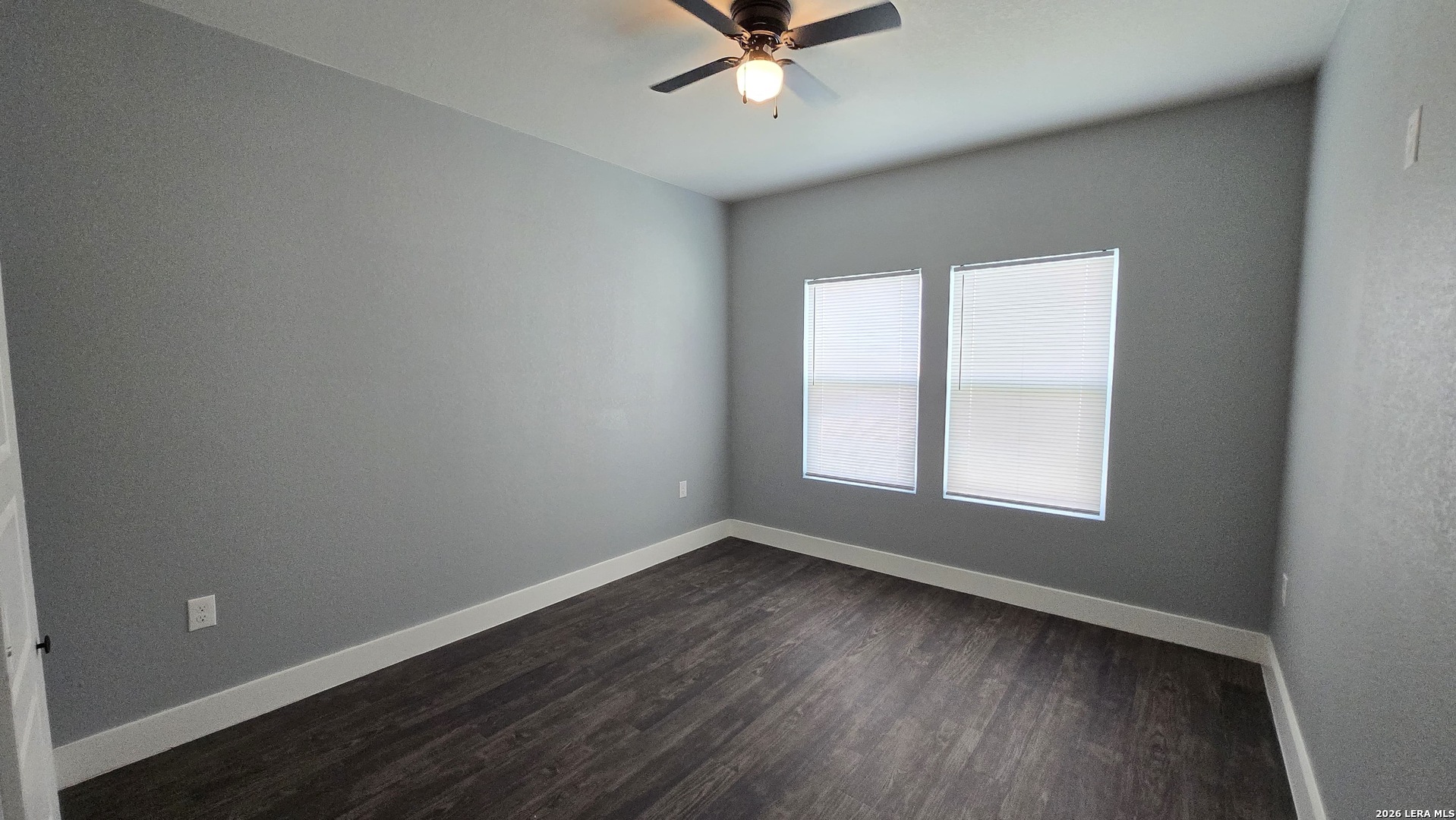 802 Cr 520 D'Hanis, TX 78850 - Photo 29 of 33 an empty room with wooden floor fan and windows