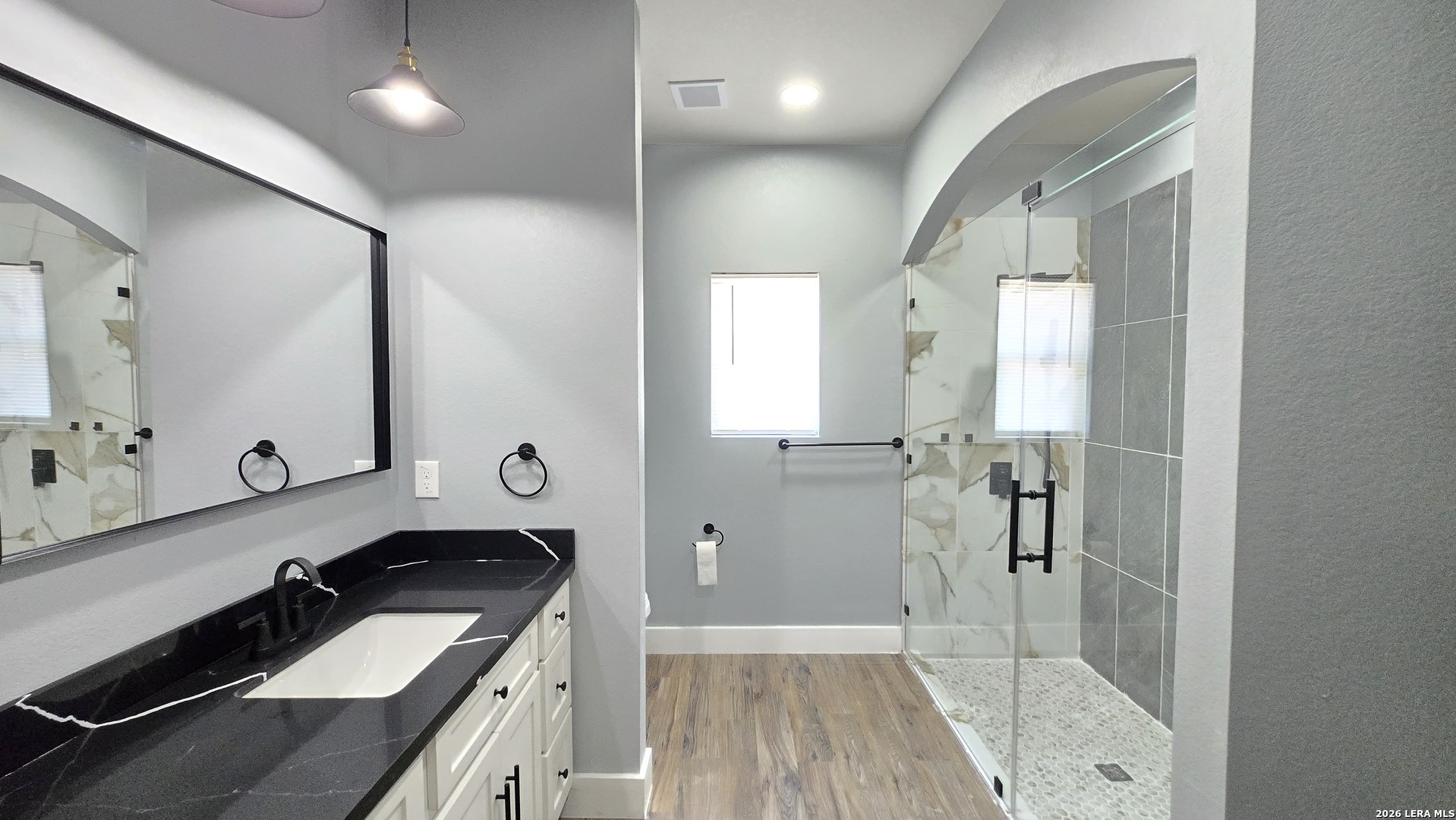 802 Cr 520 D'Hanis, TX 78850 - Photo 30 of 33 a bathroom with a sink a mirror and a shower