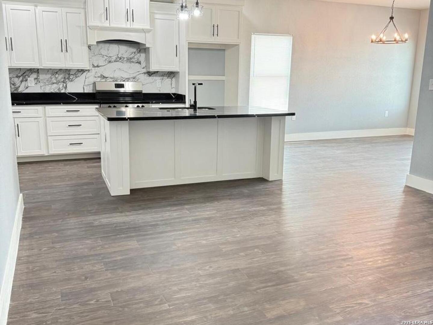 802 Cr 520 D'Hanis, TX 78850 - Photo 5 of 33 a kitchen with granite countertop a sink and cabinets