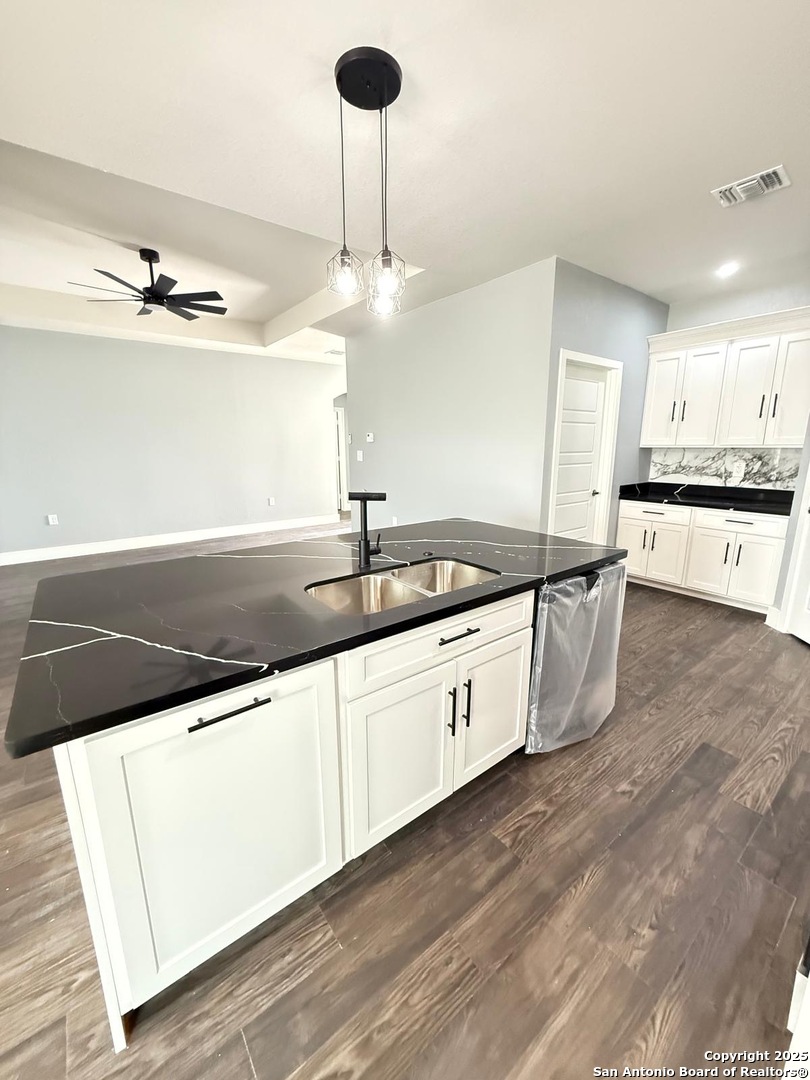 802 Cr 520 D'Hanis, TX 78850 - Photo 6 of 16 a large kitchen with stainless steel appliances kitchen island a large counter top and a wooden floors