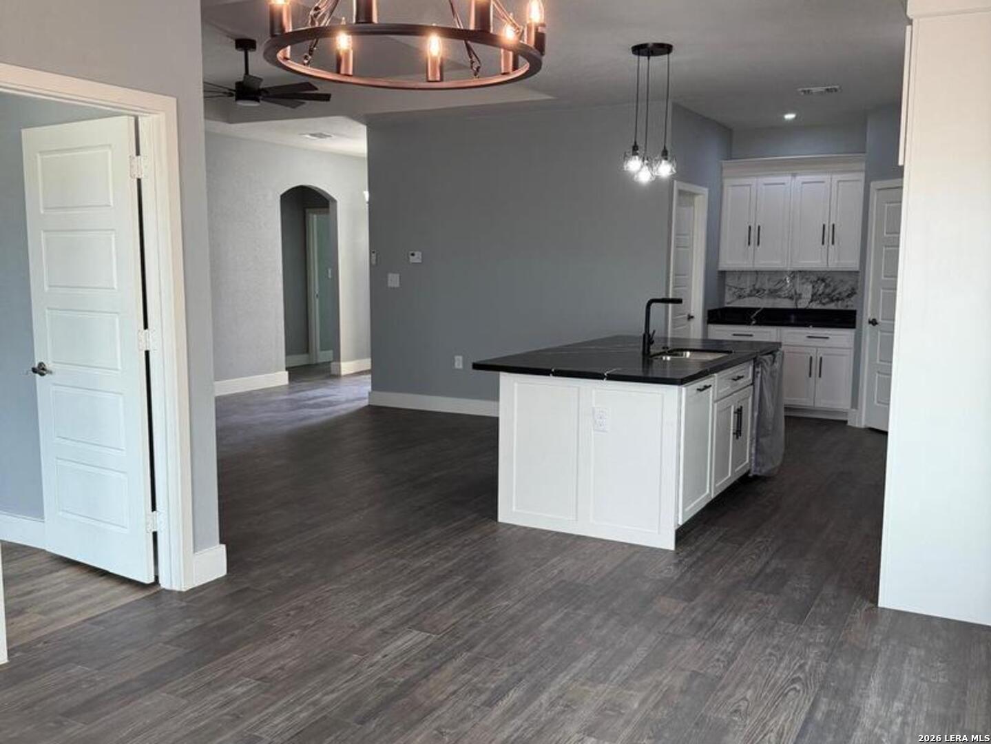 802 Cr 520 D'Hanis, TX 78850 - Photo 6 of 33 a kitchen with stainless steel appliances granite countertop a sink a stove and a wooden floors