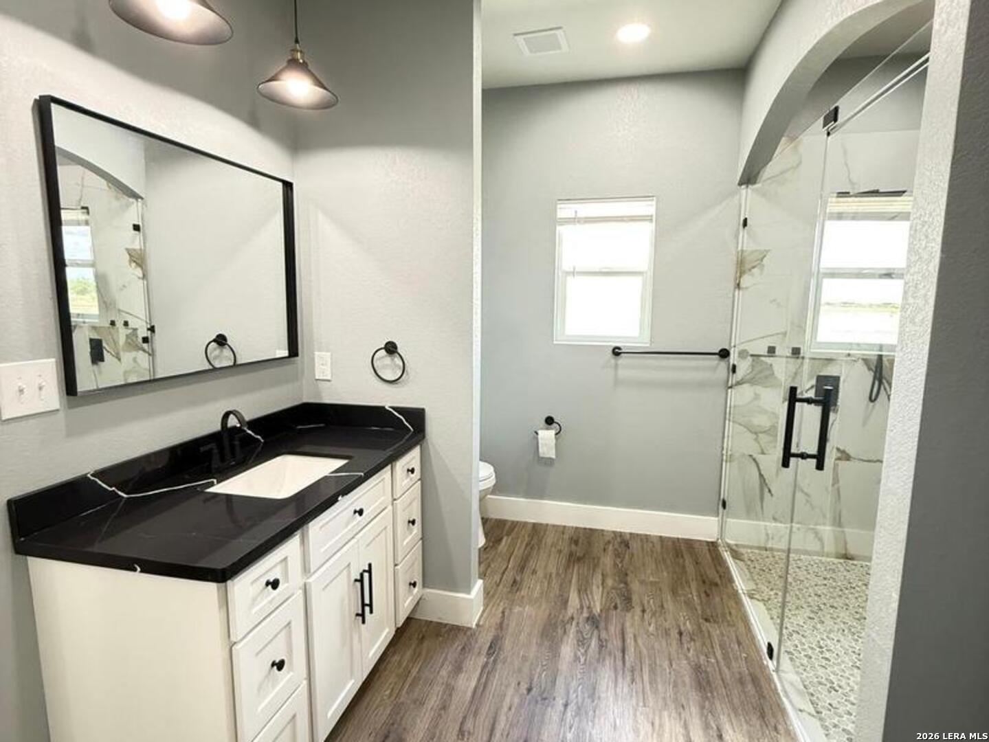 802 Cr 520 D'Hanis, TX 78850 - Photo 8 of 33 a kitchen with a sink stove and wooden floor