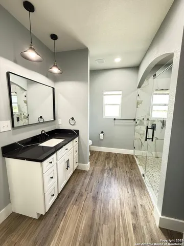 a large kitchen with a stove and a wooden floor