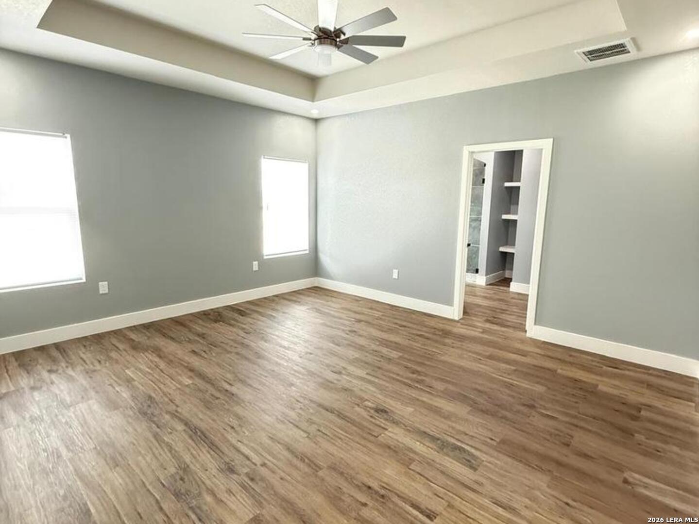 802 Cr 520 D'Hanis, TX 78850 - Photo 10 of 33 an empty room with wooden floor fan and windows
