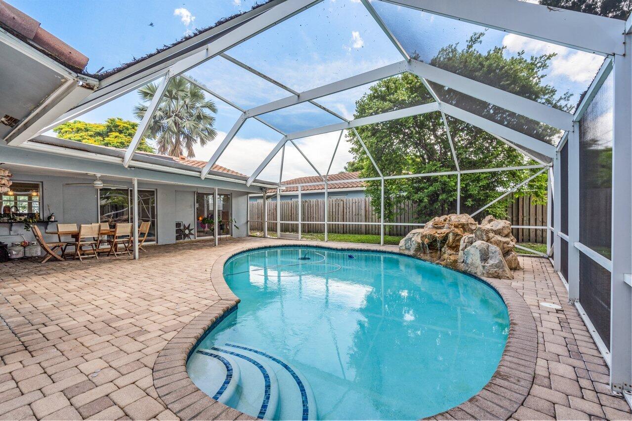 105 Orchard Ridge Lane Boca Raton, FL 33431 - Photo 28 of 37 a view of a swimming pool with a patio