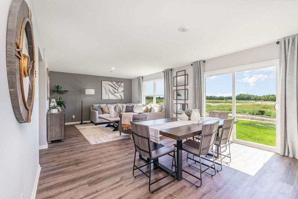 615 Ensign Place Hebron, IN 46341 - Photo 12 of 29 a view of a dining room with furniture window and wooden floor