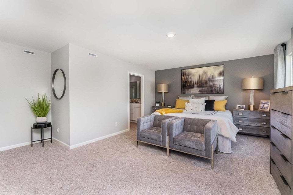 615 Ensign Place Hebron, IN 46341 - Photo 20 of 29 a bedroom with bed and paintings on the wall