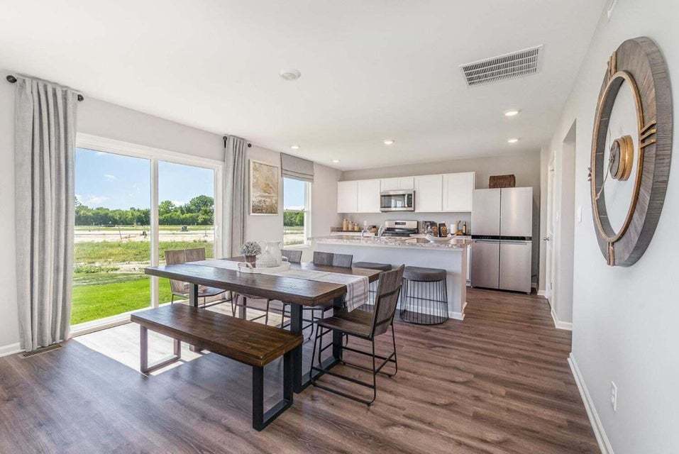 615 Ensign Place Hebron, IN 46341 - Photo 10 of 29 a view of a dining room with furniture window and wooden floor