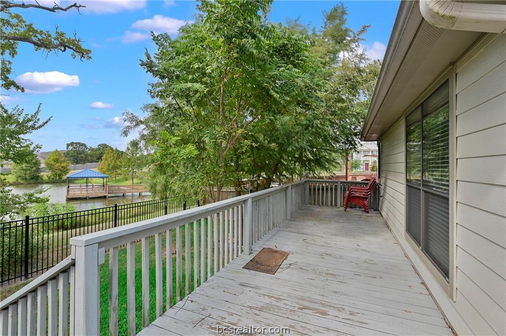 2004 Spring Leaf Court Bryan, TX 77807 - Photo 15 of 19 Wooden deck featuring a water view and fence