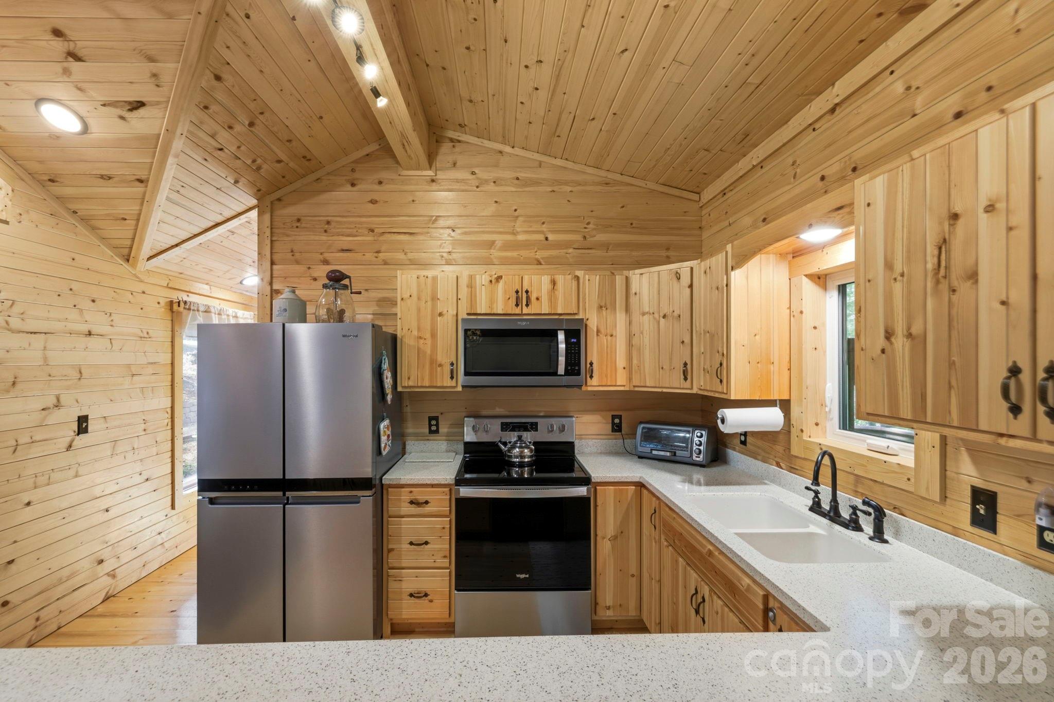 81 Delind Drive Mill Spring, NC 28756 - Photo 11 of 40 a kitchen with a refrigerator a sink and a stove