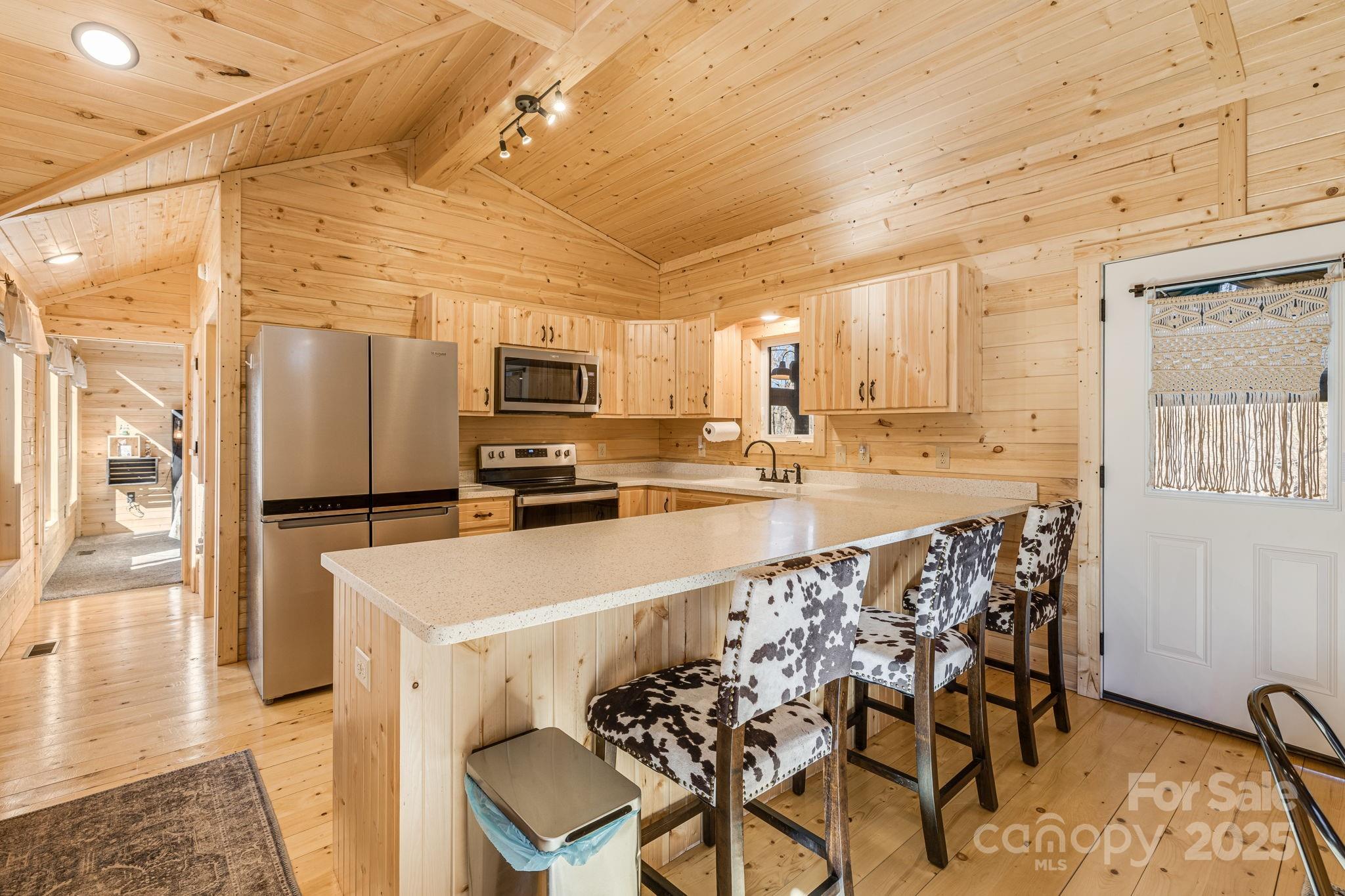 81 Delind Drive Mill Spring, NC 28756 - Photo 12 of 40 a kitchen with stainless steel appliances a microwave a stove a sink a refrigerator and cabinets