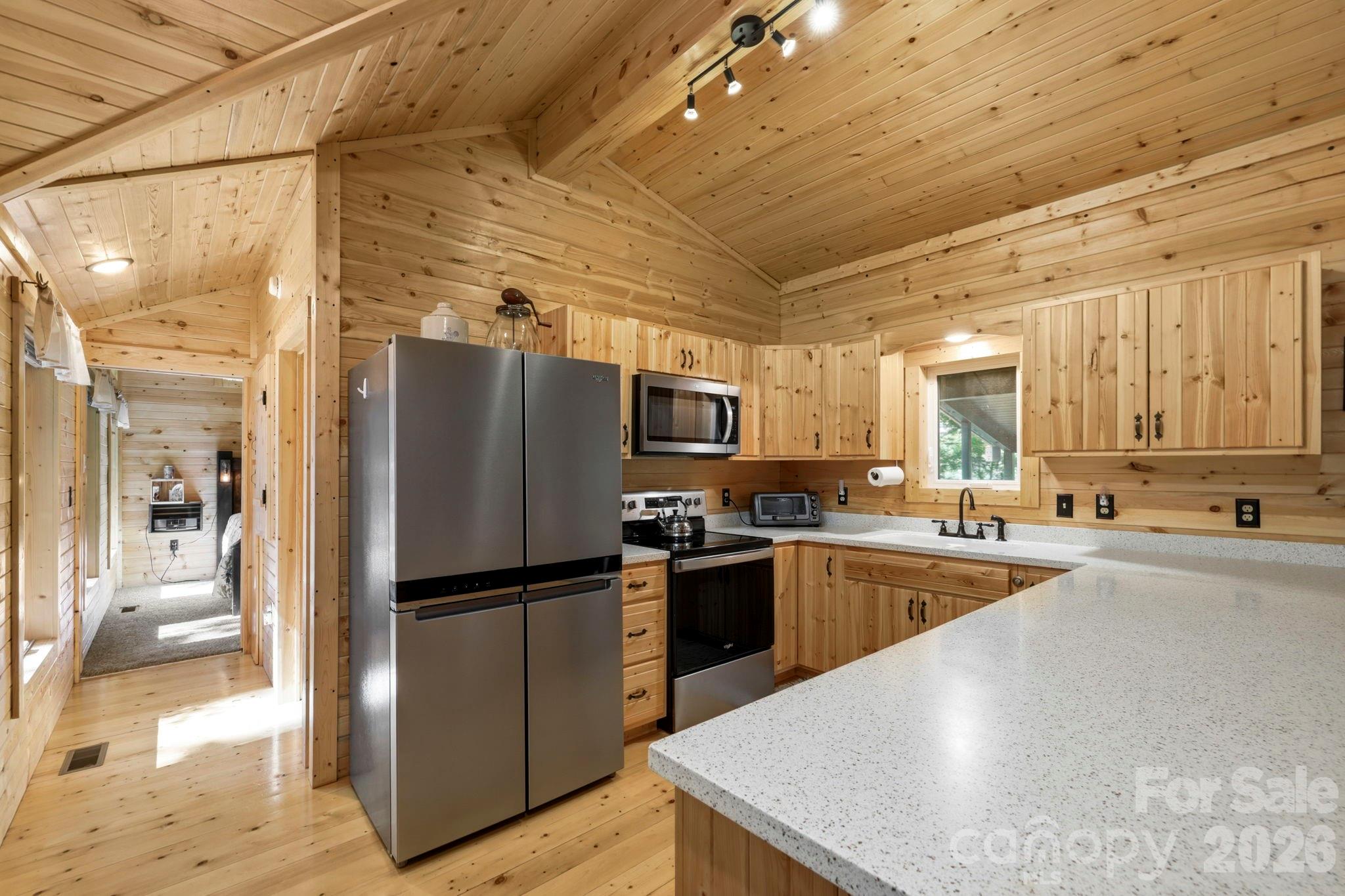 81 Delind Drive Mill Spring, NC 28756 - Photo 12 of 40 a kitchen with refrigerator and stove