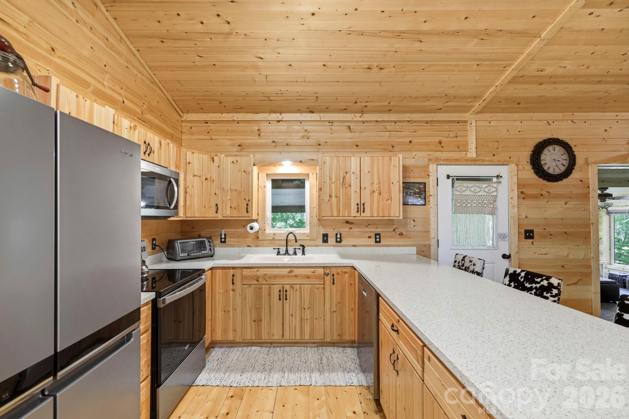 81 Delind Drive Mill Spring, NC 28756 - Photo 13 of 40 a kitchen with a sink cabinets and stainless steel appliances