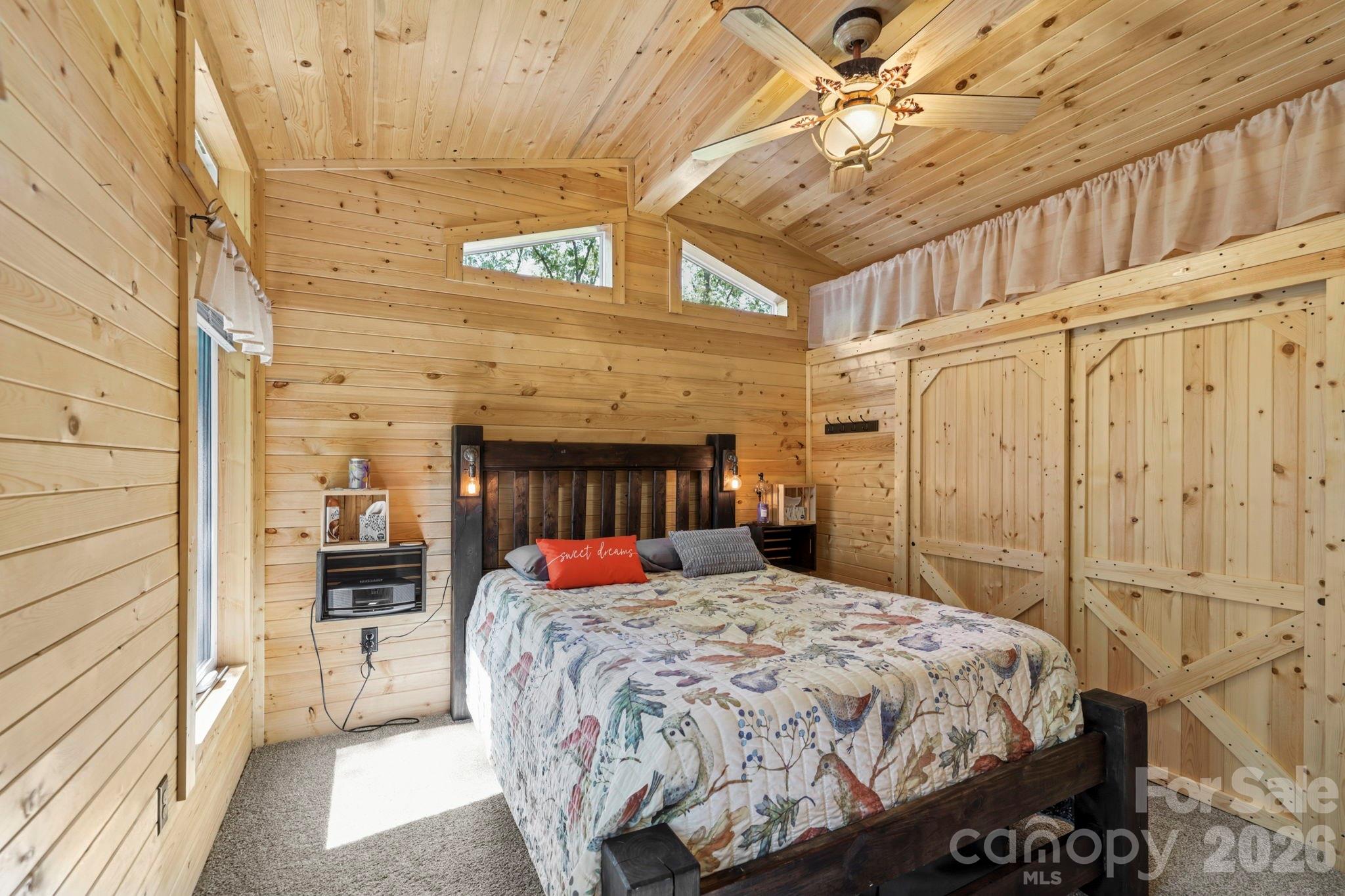 81 Delind Drive Mill Spring, NC 28756 - Photo 15 of 40 a bedroom with a bed and a mirror