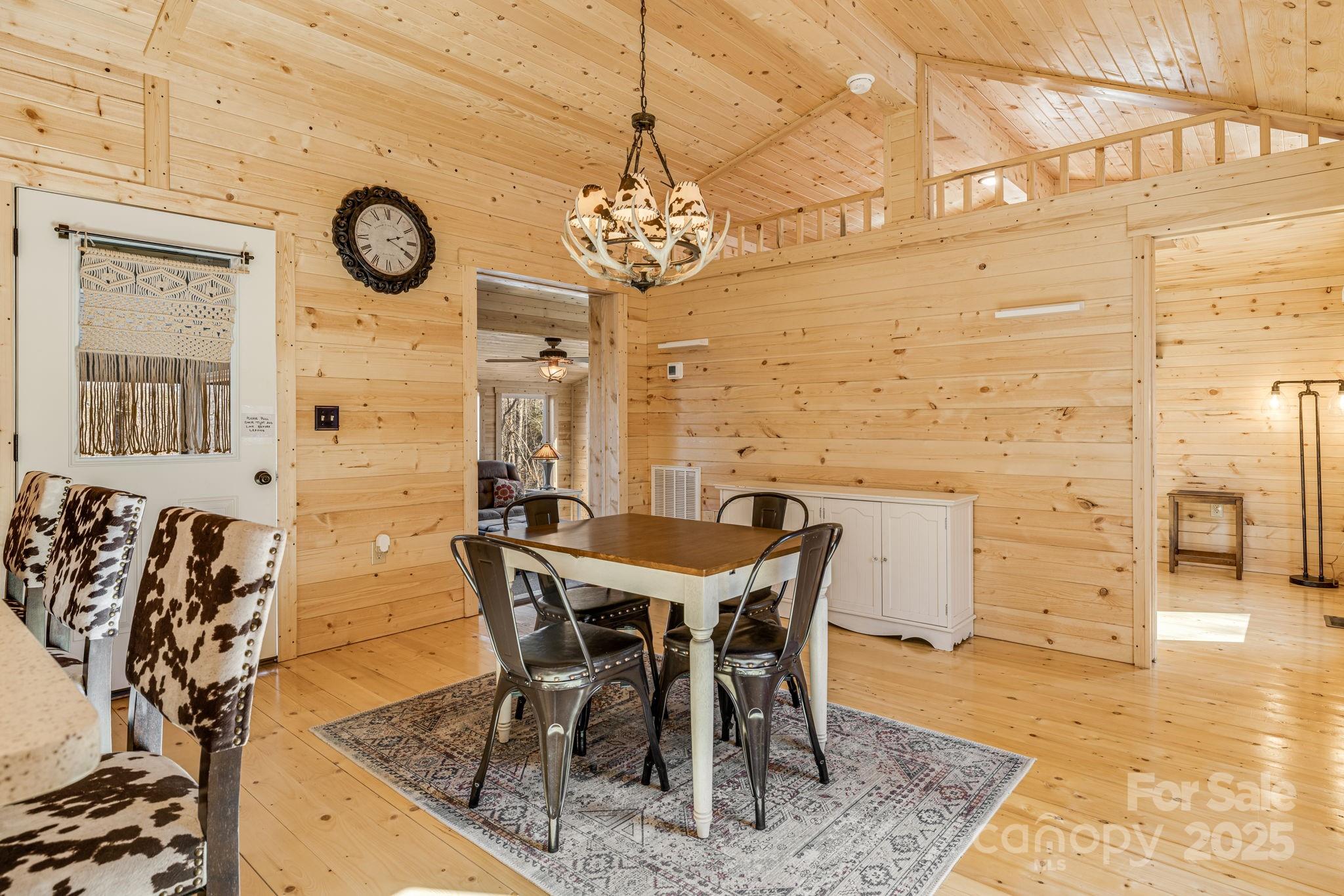 81 Delind Drive Mill Spring, NC 28756 - Photo 15 of 40 a view of a dining room with furniture and a clock