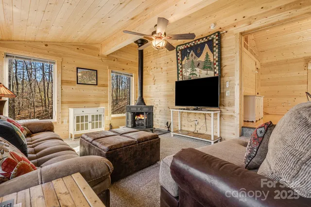 a living room with furniture a flat screen tv and a window