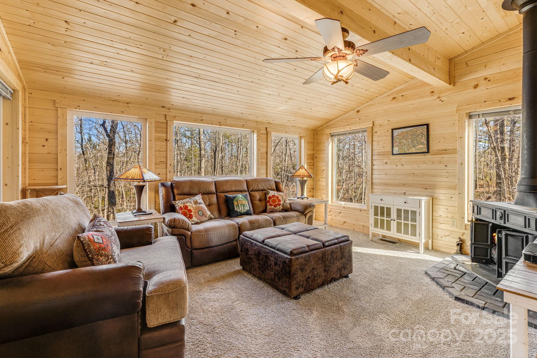 81 Delind Drive Mill Spring, NC 28756 - Photo 18 of 40 a living room with furniture and a floor to ceiling window