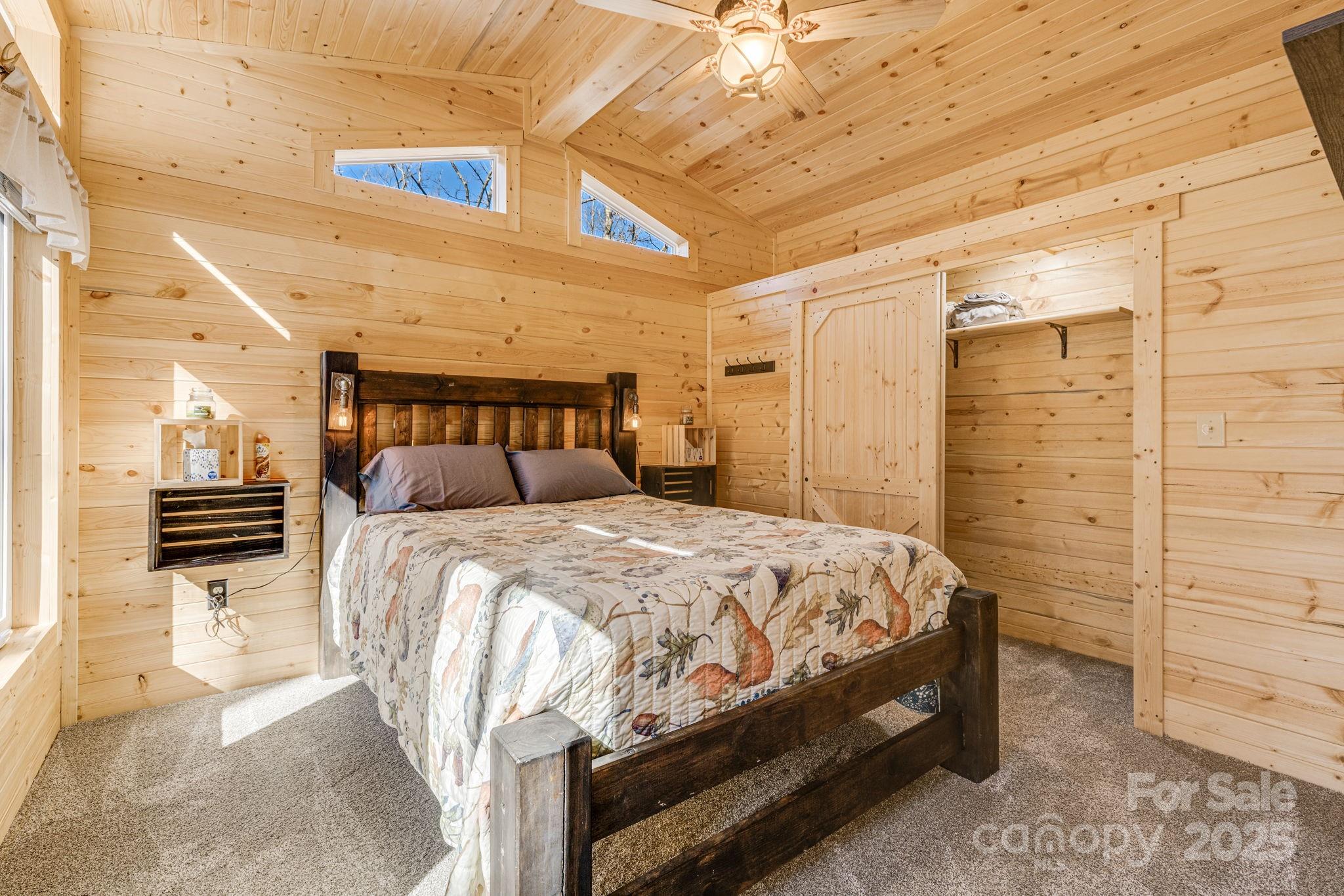 81 Delind Drive Mill Spring, NC 28756 - Photo 19 of 40 a bedroom with a bed and a walk in closet