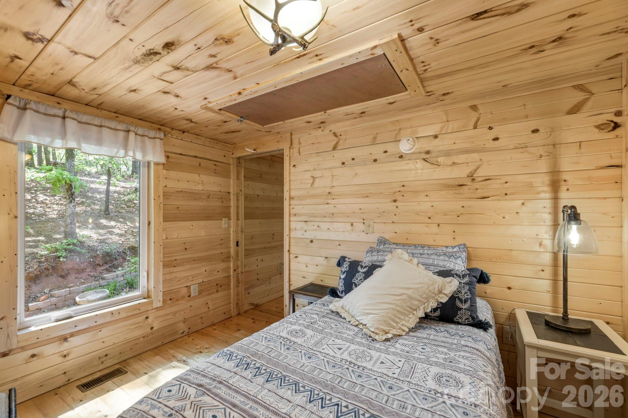 81 Delind Drive Mill Spring, NC 28756 - Photo 20 of 40 a bedroom with a bed and wooden floor