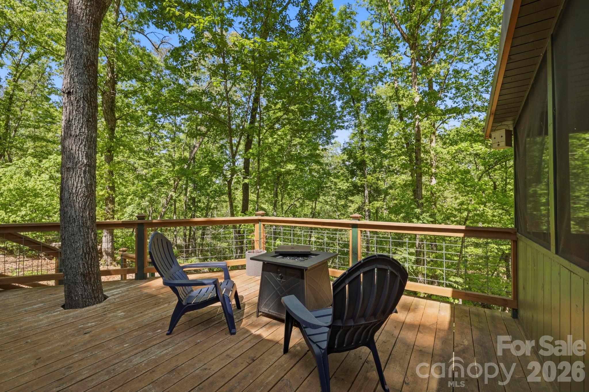 81 Delind Drive Mill Spring, NC 28756 - Photo 23 of 40 a balcony with wooden floor table and chairs