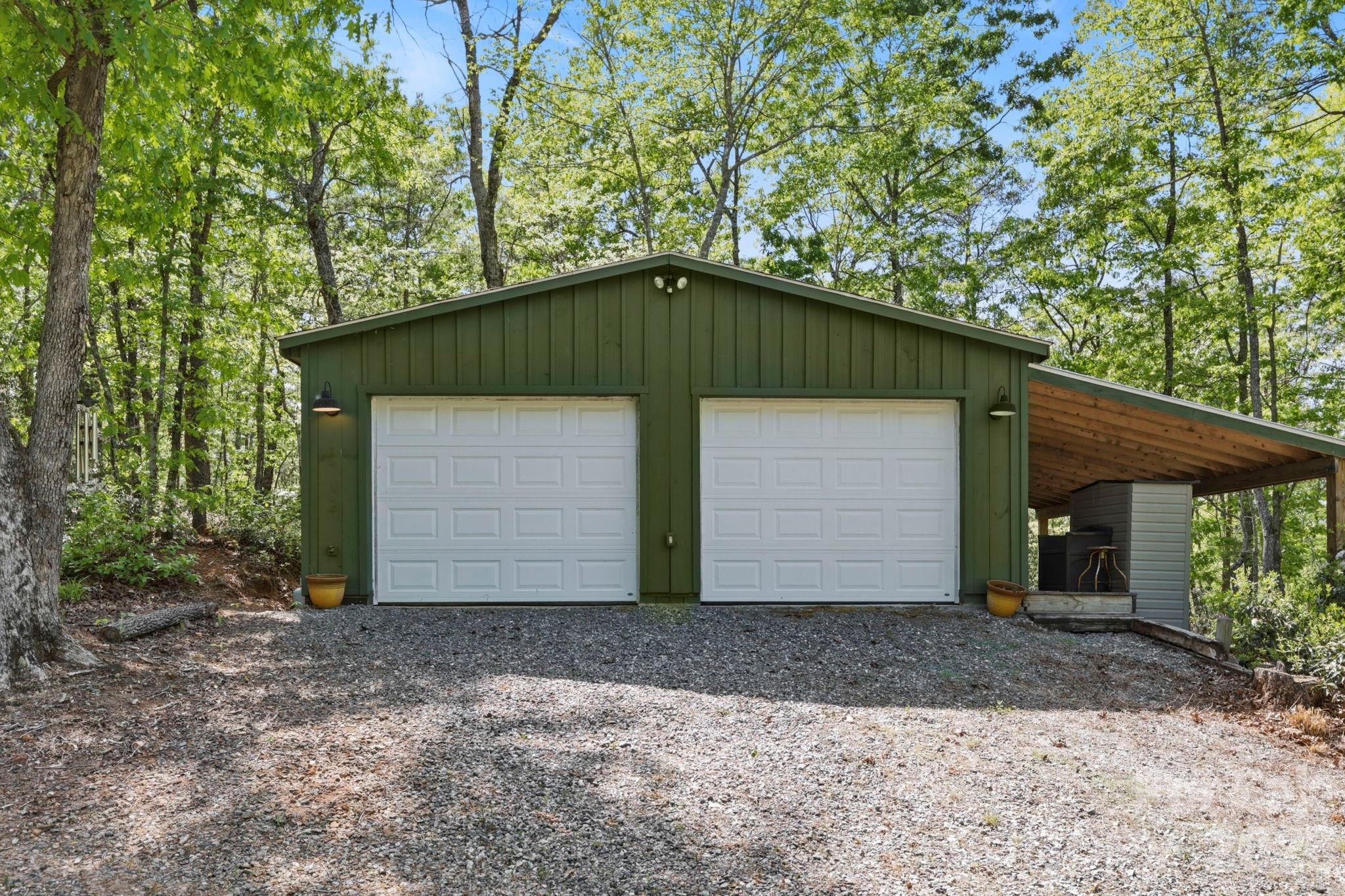 81 Delind Drive Mill Spring, NC 28756 - Photo 25 of 40 a front view of a house with garden