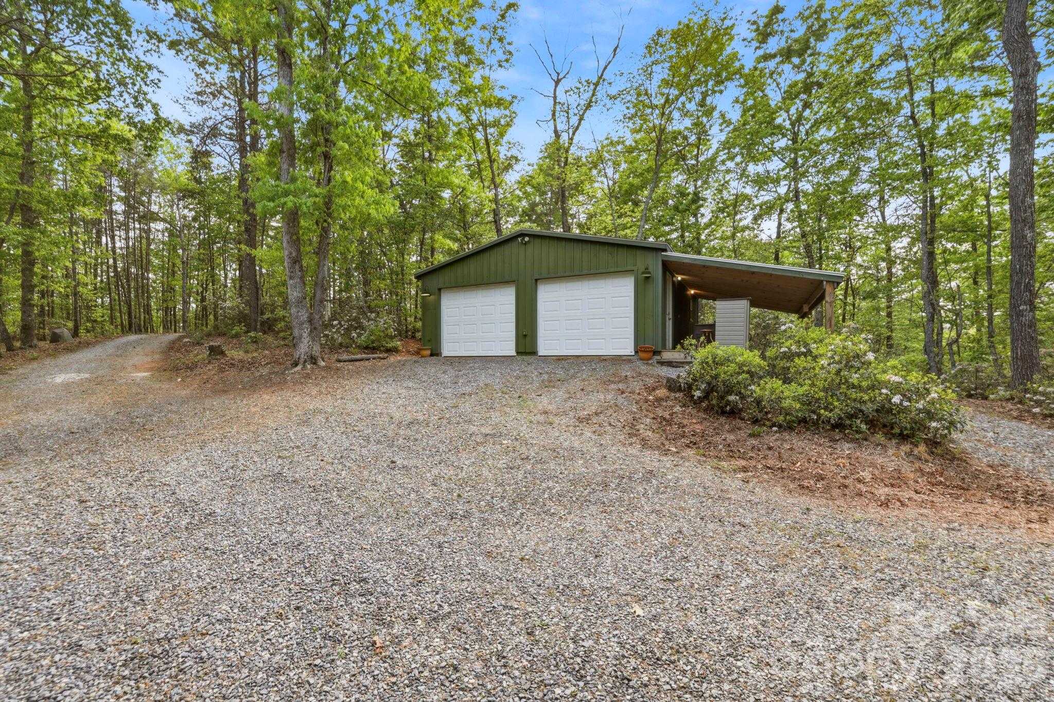 81 Delind Drive Mill Spring, NC 28756 - Photo 28 of 40 a front view of a house with plants and trees