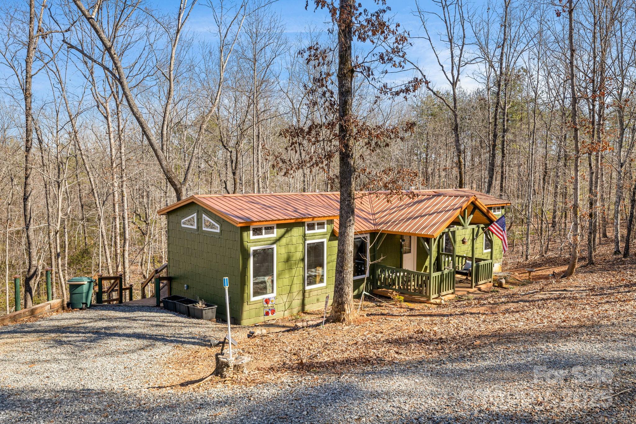 81 Delind Drive Mill Spring, NC 28756 - Photo 3 of 40 a view of a house with a yard and sitting area
